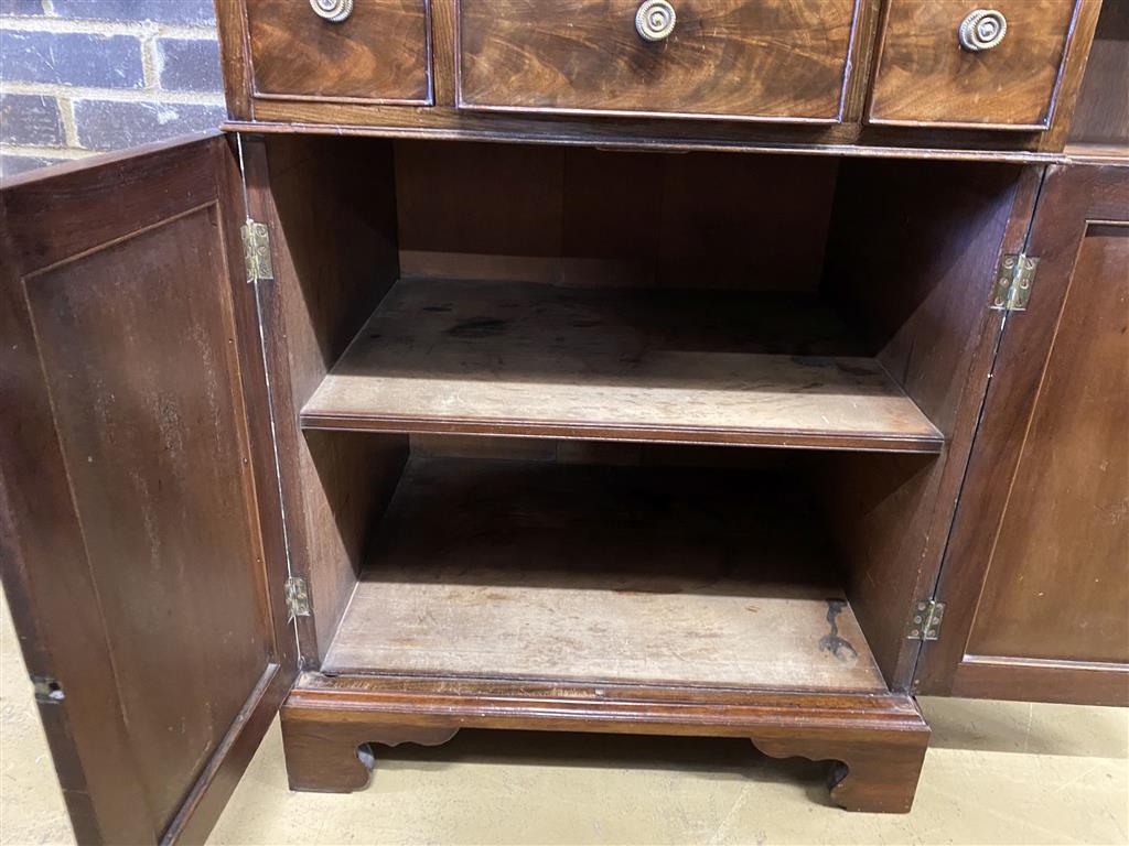 A Regency mahogany cupboard, fitted four drawers over a pair of fielded panelled doors (altered), width 69cm, depth 56cm, height 104cm